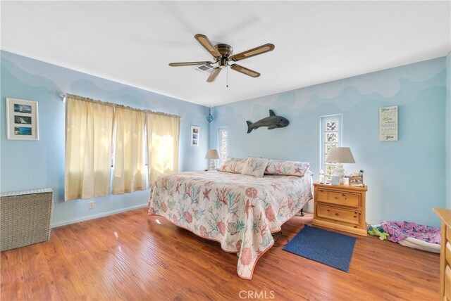 bedroom with ceiling fan and hardwood / wood-style flooring