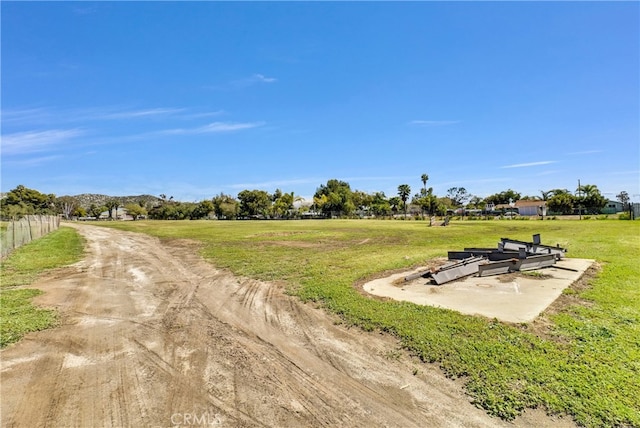 view of home's community with a lawn and a rural view