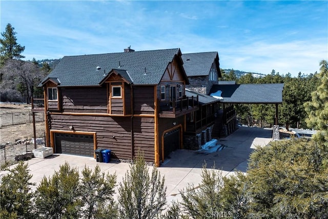 rear view of property featuring a garage