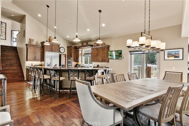 dining area featuring a chandelier, dark hardwood / wood-style flooring, and high vaulted ceiling