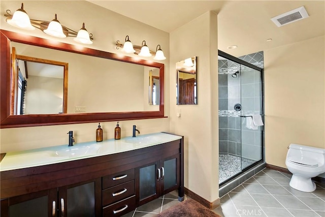 bathroom with toilet, walk in shower, vanity, and tile patterned flooring