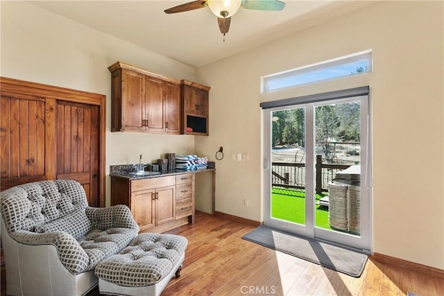 sitting room with ceiling fan, sink, and light hardwood / wood-style floors