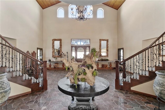 entryway with a notable chandelier and a towering ceiling