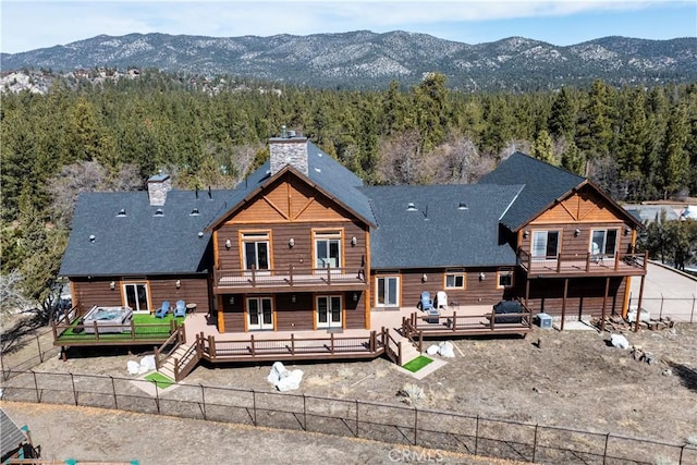 back of property featuring a deck with mountain view