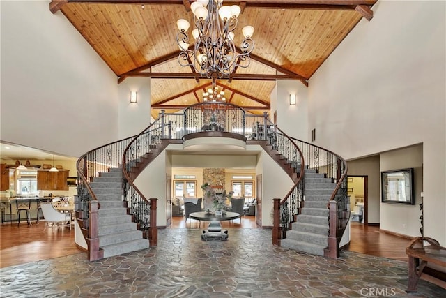 foyer featuring high vaulted ceiling, beam ceiling, wood ceiling, and an inviting chandelier