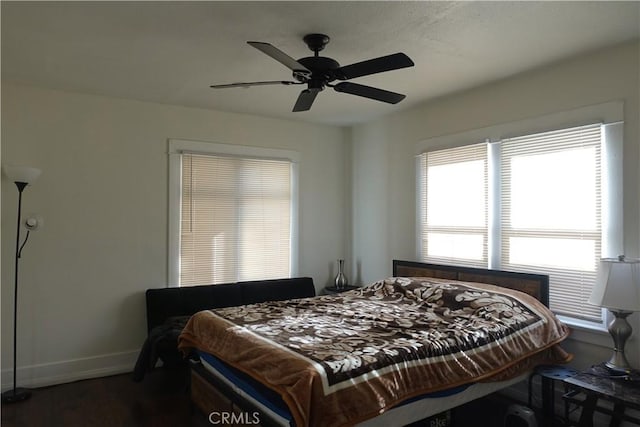 bedroom with ceiling fan and dark hardwood / wood-style floors