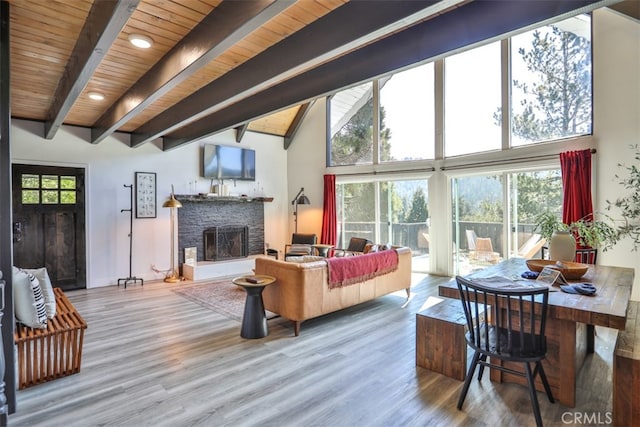 living room featuring a high ceiling, wooden ceiling, beam ceiling, and hardwood / wood-style floors