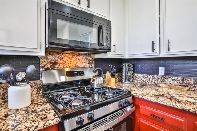 kitchen featuring decorative backsplash, white cabinetry, and stainless steel range with gas stovetop