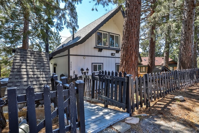 rear view of house featuring a wooden deck