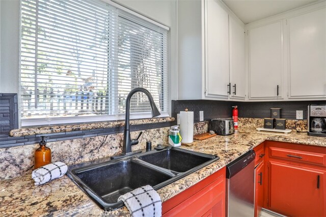 kitchen featuring sink, white cabinets, and dishwasher