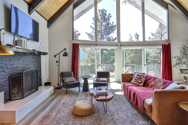 living room with wooden ceiling, a fireplace, wood-type flooring, and high vaulted ceiling