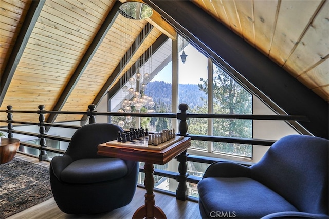 living area featuring hardwood / wood-style floors, vaulted ceiling with beams, and wooden ceiling