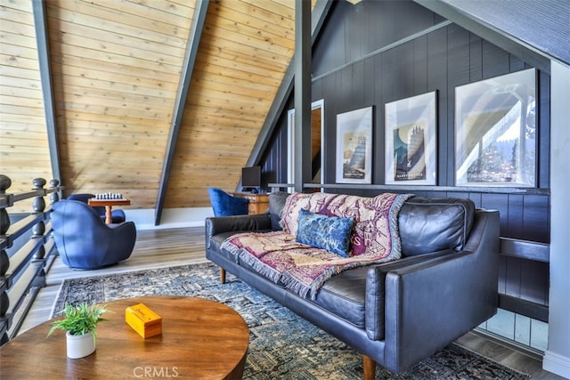 living room featuring wood ceiling, wood-type flooring, beamed ceiling, wooden walls, and high vaulted ceiling