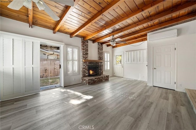 unfurnished living room featuring ceiling fan, hardwood / wood-style flooring, wooden ceiling, an AC wall unit, and beamed ceiling