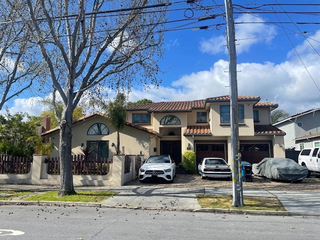 mediterranean / spanish-style home with a garage