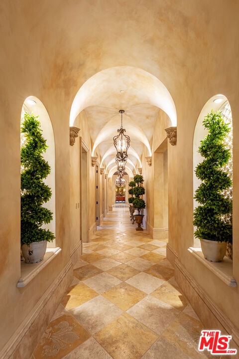 hall with an inviting chandelier