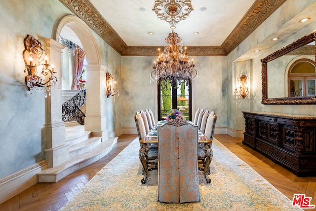 dining space featuring ornate columns, a notable chandelier, and light parquet flooring