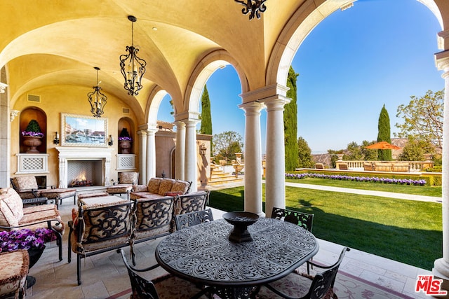 view of patio / terrace with an outdoor living space with a fireplace