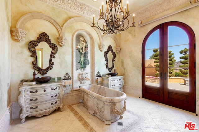 entryway with french doors, a chandelier, and plenty of natural light