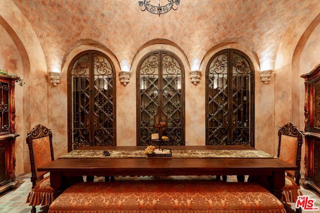 wine cellar with lofted ceiling and brick ceiling