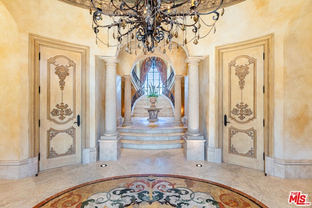 interior space with a notable chandelier and decorative columns