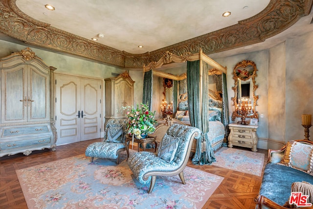 sitting room featuring parquet flooring and french doors