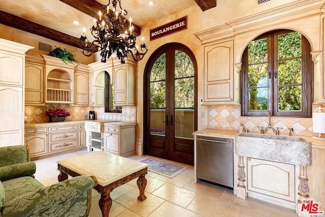 kitchen with beam ceiling, stainless steel dishwasher, french doors, and light brown cabinetry