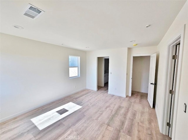 spare room featuring light hardwood / wood-style floors