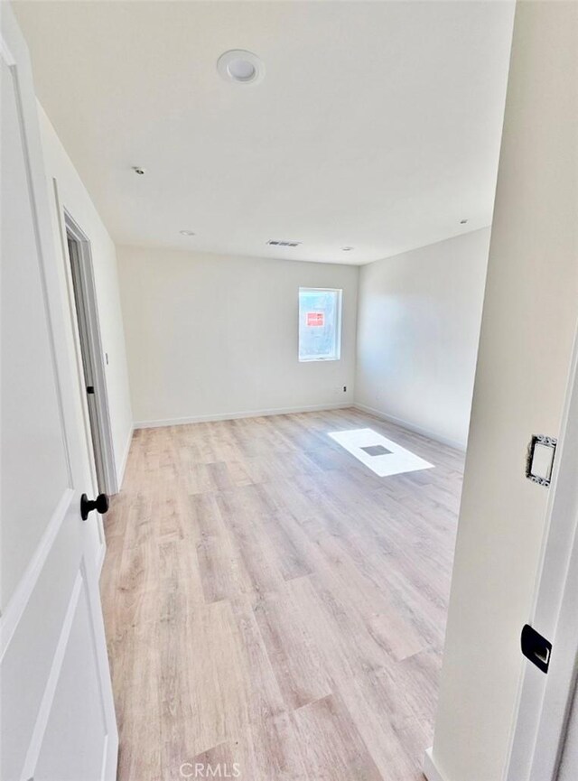 spare room featuring light hardwood / wood-style flooring