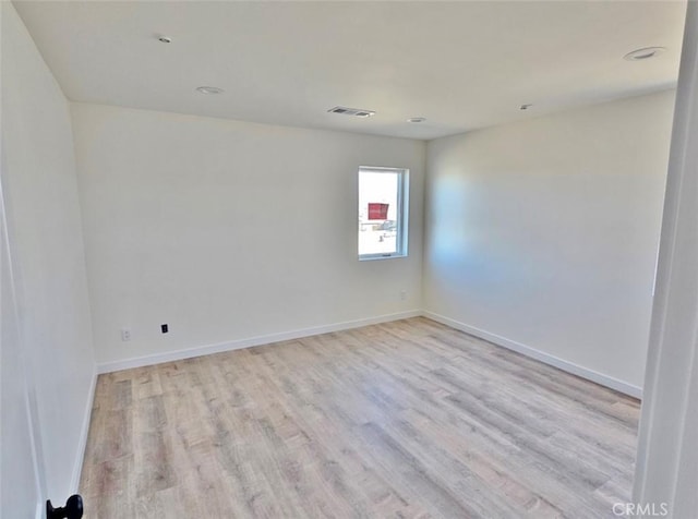 spare room featuring light hardwood / wood-style flooring