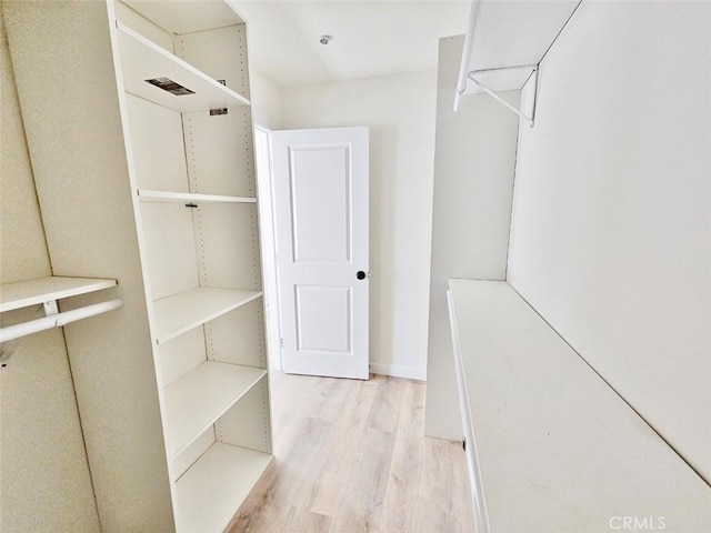 walk in closet featuring light hardwood / wood-style floors