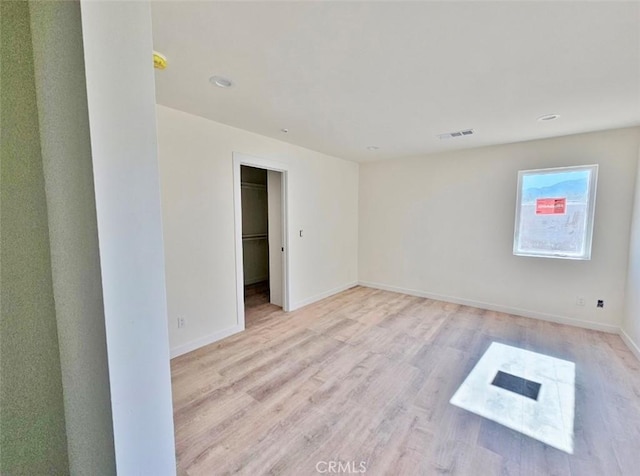 spare room with light wood-type flooring