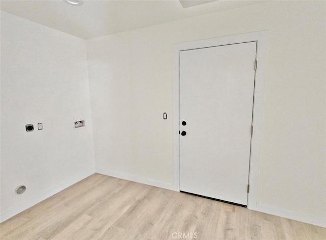 laundry area featuring hookup for an electric dryer and light hardwood / wood-style flooring