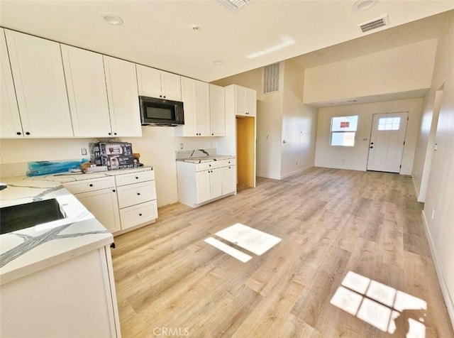 kitchen featuring light hardwood / wood-style flooring and white cabinetry