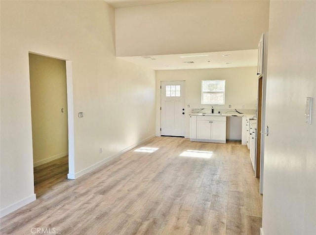 clothes washing area featuring light hardwood / wood-style floors and sink