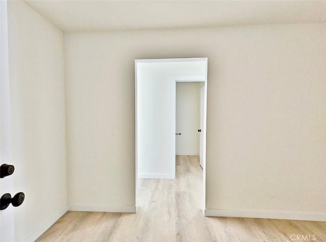 empty room with light hardwood / wood-style flooring