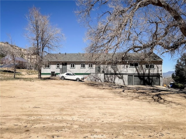 back of property featuring a garage