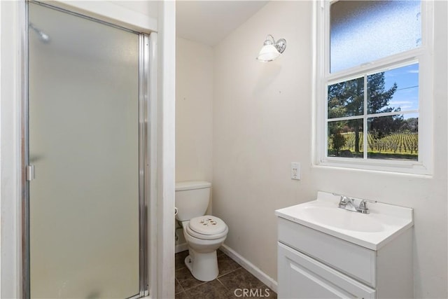 bathroom with tile patterned flooring, baseboards, toilet, a stall shower, and vanity