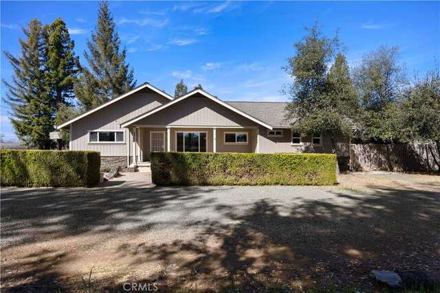 ranch-style home with fence