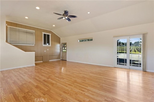 unfurnished living room featuring baseboards, wood finished floors, a ceiling fan, and vaulted ceiling