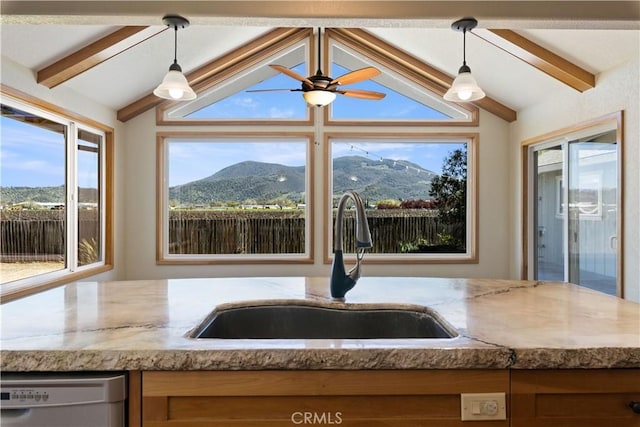 kitchen with decorative light fixtures, dishwasher, lofted ceiling with beams, and a sink