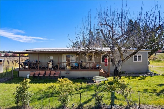 rear view of property with a yard