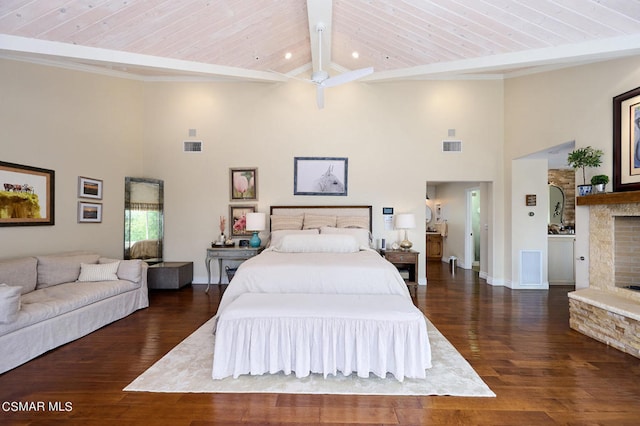 bedroom with a fireplace, dark hardwood / wood-style flooring, wooden ceiling, and beamed ceiling