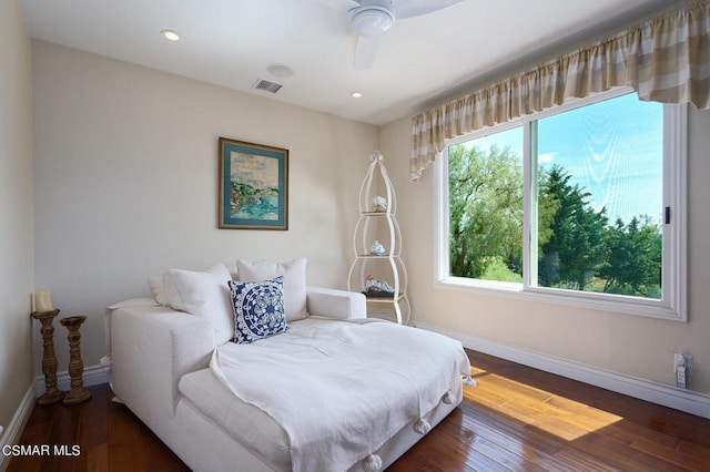 bedroom with dark hardwood / wood-style floors and ceiling fan