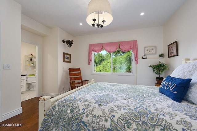 bedroom with dark hardwood / wood-style flooring and connected bathroom