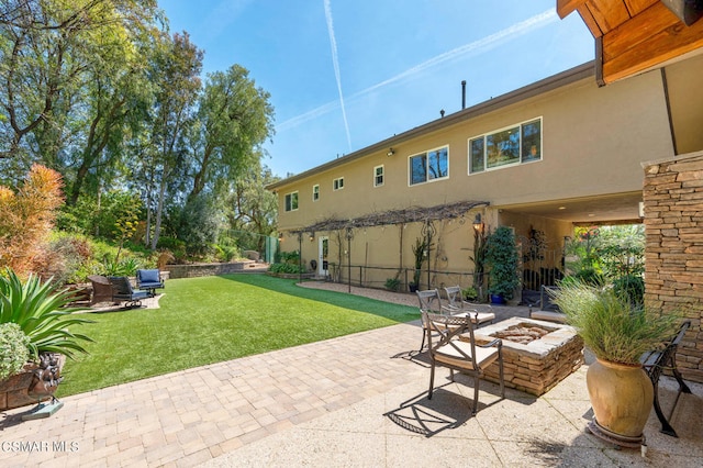 view of patio / terrace featuring an outdoor fire pit