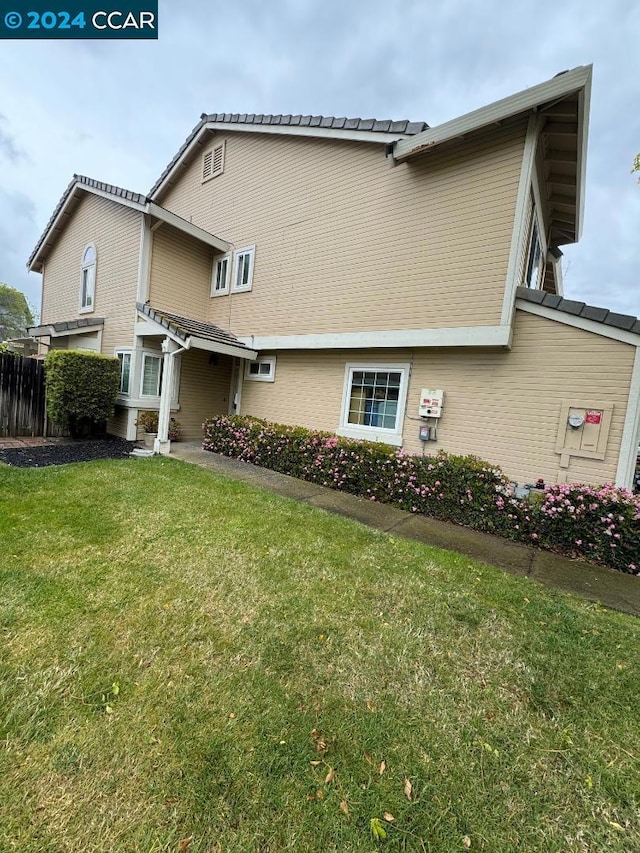 rear view of property with a lawn