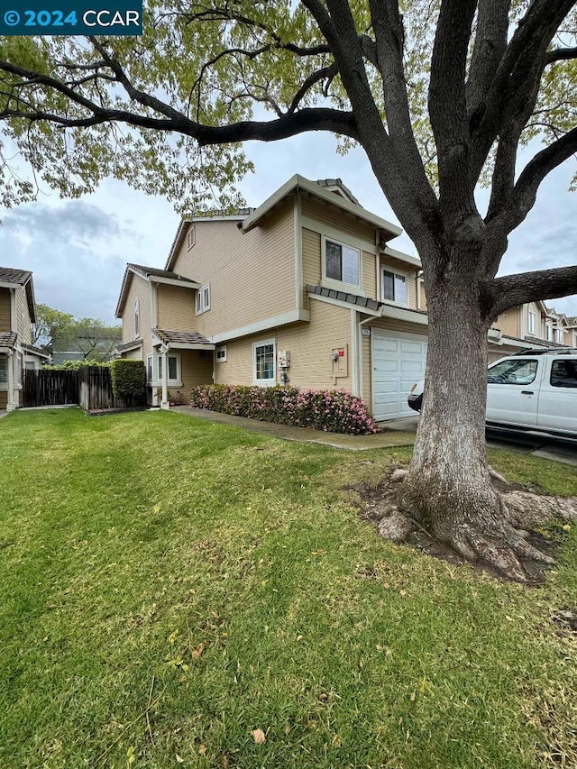 view of property exterior with a garage and a lawn