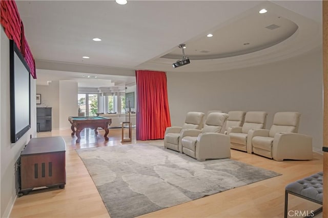 cinema with crown molding, a tray ceiling, billiards, and hardwood / wood-style flooring