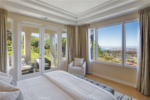 bedroom featuring hardwood / wood-style floors, access to exterior, and french doors